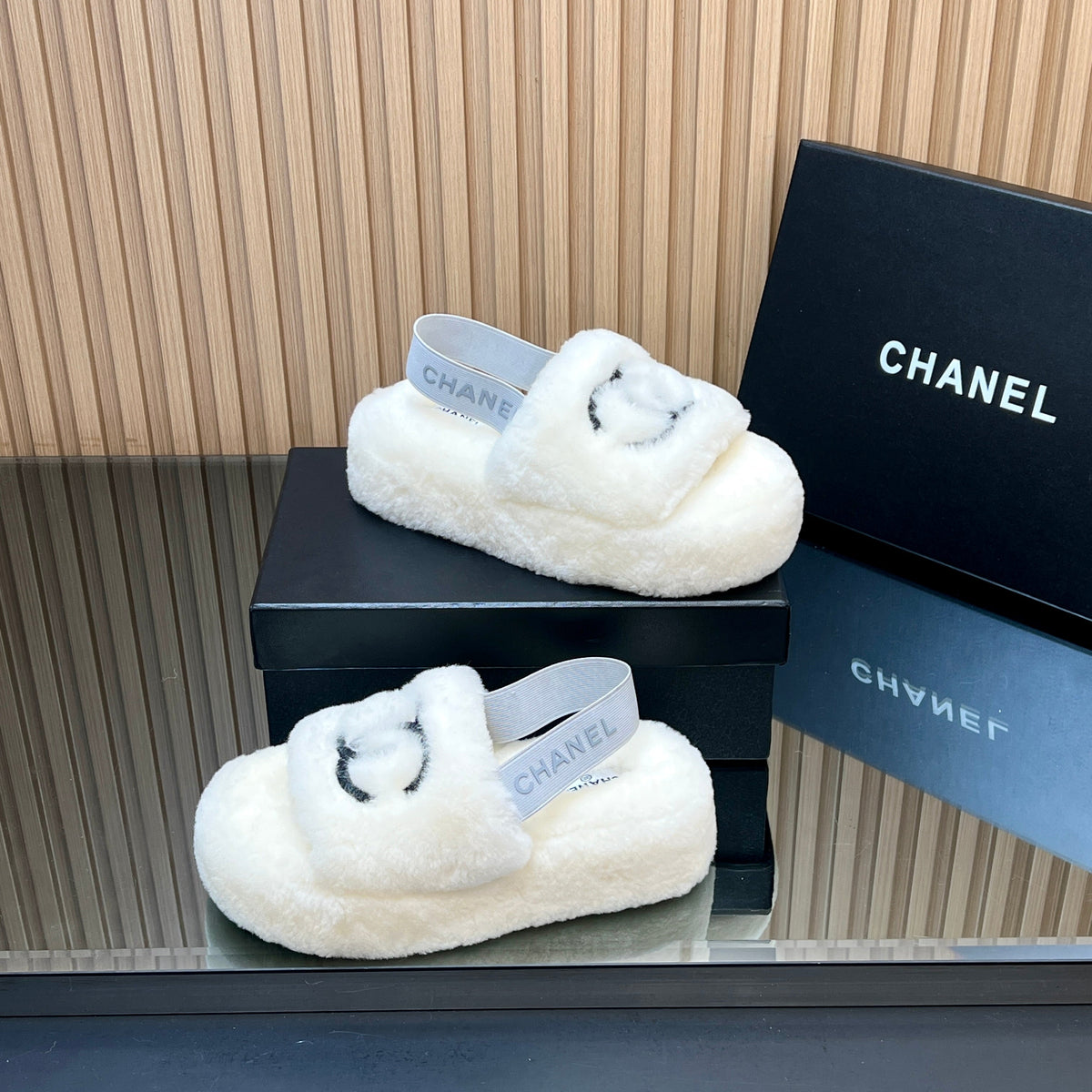 CHANEL 25S THICK-SOLED FURRY SLIPPERS WITH ELASTIC STRAPS IN WHITE FUR